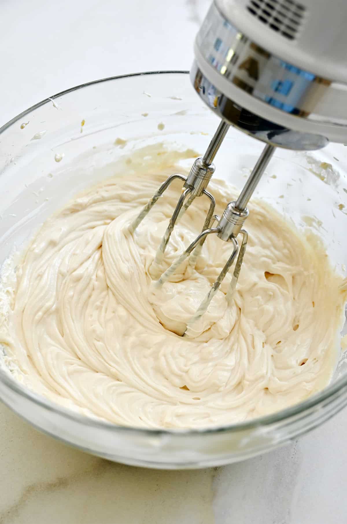 Blended no-bake cheesecake in a mixing bowl.
