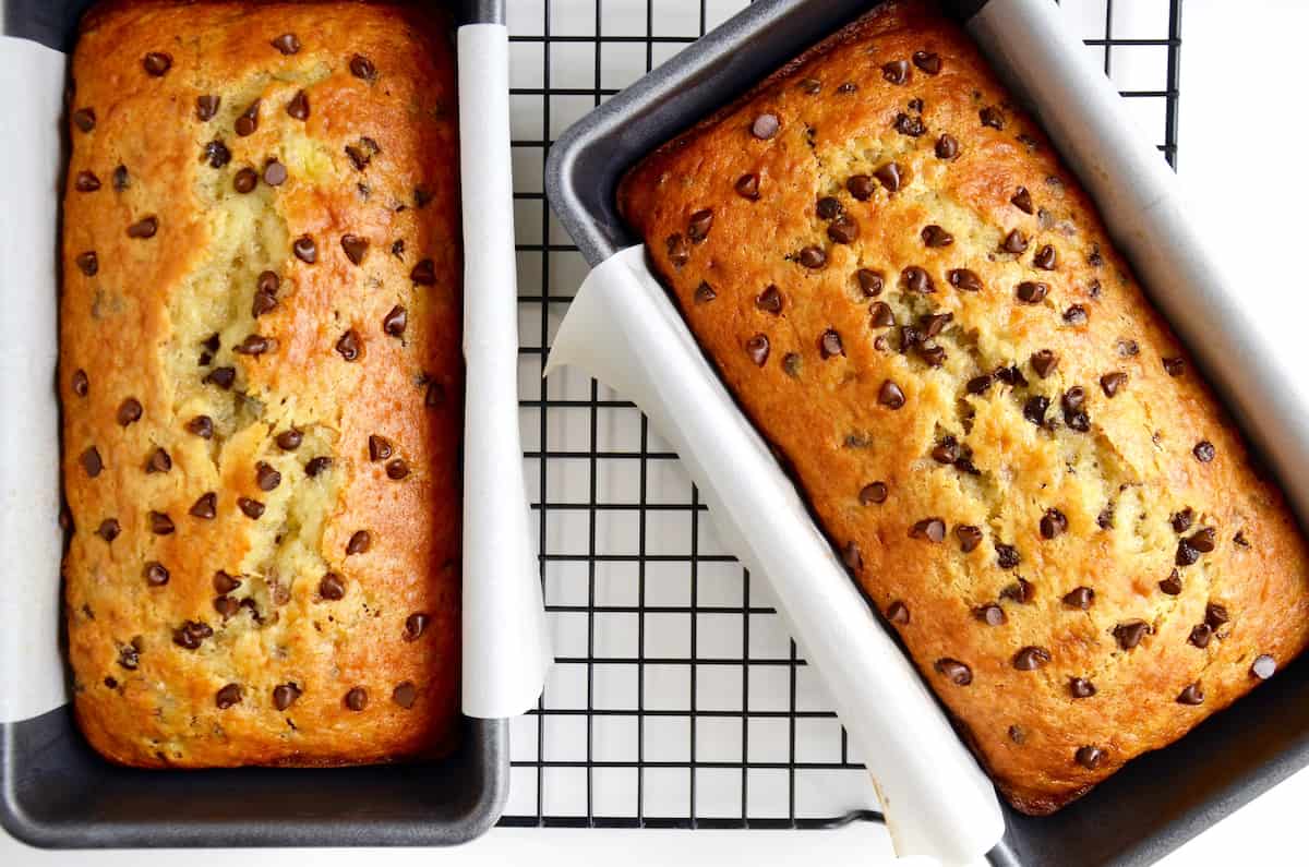 Two bread loaves containing cake mix banana bread studded with mini chocolate chips.