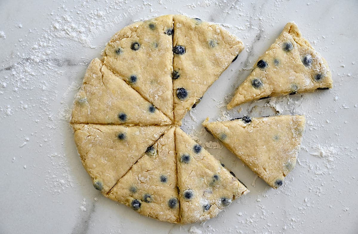 Blueberry scone batter cut into perfect triangles.