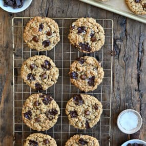 A top-down view of soft and chewy Flourless Oatmeal Chocolate Chip Cookies cooling on a wire rack