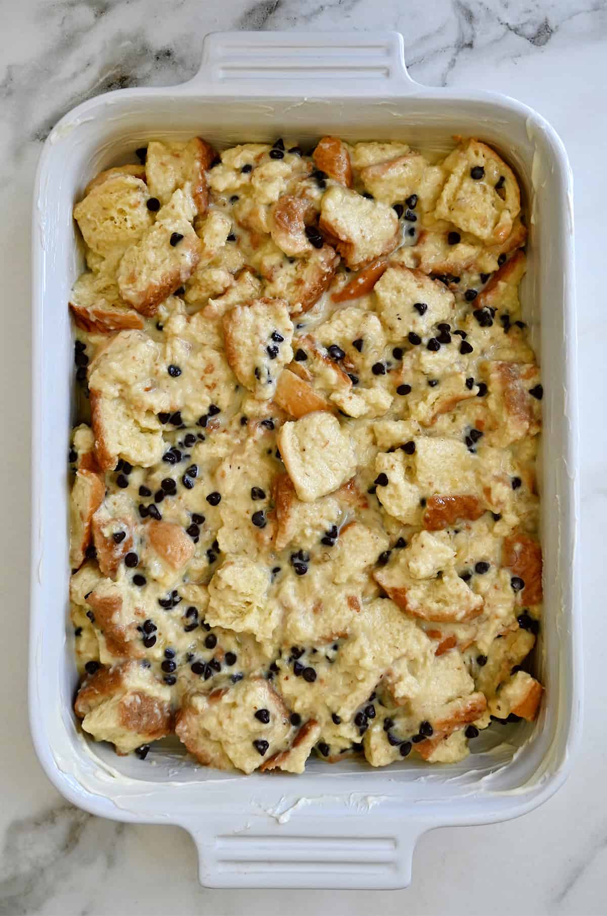 Unbaked bread pudding with mini chocolate chips.