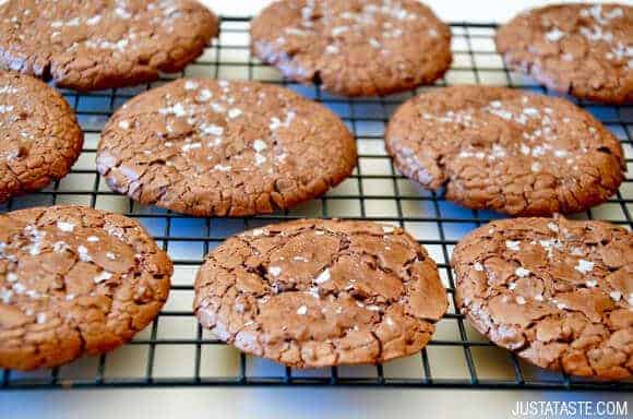 Flourless Chocolate Cookies topped with sea salt on wire cooling rack