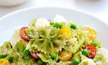 Pea Pesto Pasta Salad topped with fresh mozzarella cheese, cherry tomatoes and Parmesan cheese