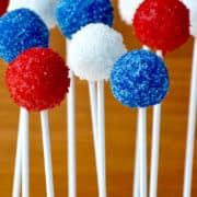 Red, white and blue Oreo cookie pops on white lollipop sticks.