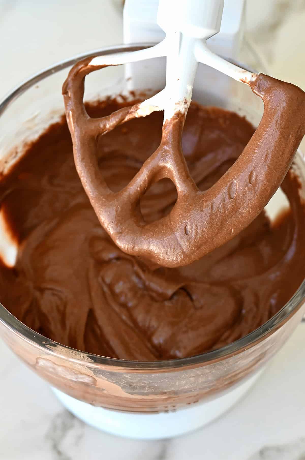 Chocolate cake batter in the bowl of a stand mixer.
