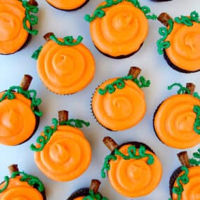 Chocolate Halloween cupcakes with orange frosting to look like a pumpkin patch.