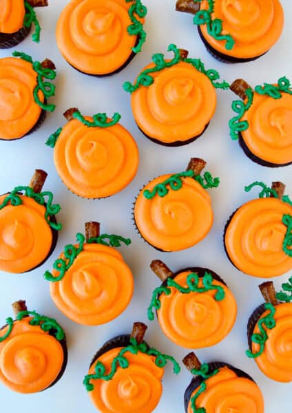 Chocolate Halloween cupcakes with orange frosting to look like a pumpkin patch.