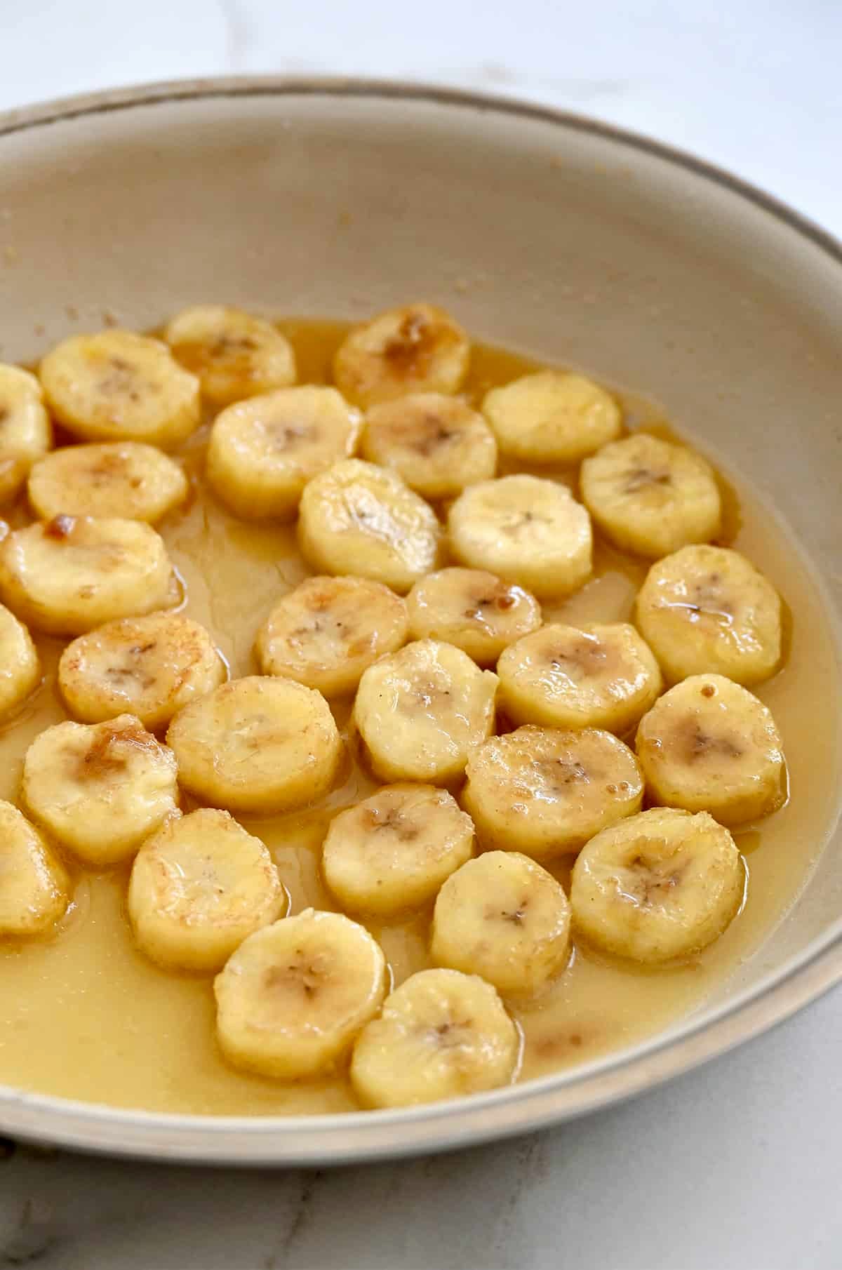 Making caramelized banana slices with brown sugar, butter and orange juice.