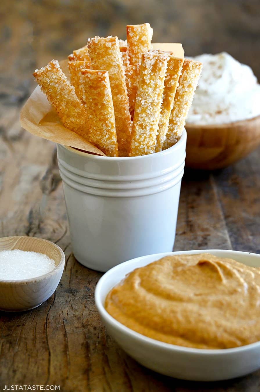A white container with pie crust fries in parchment paper