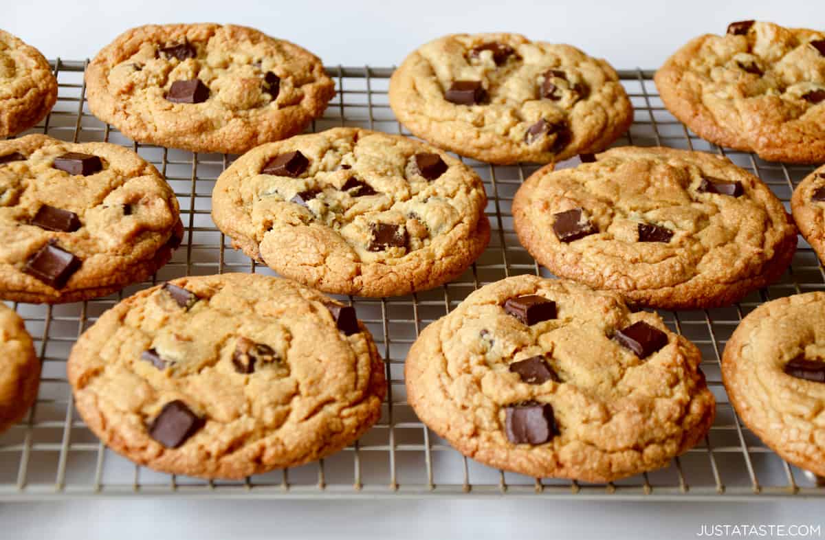 Peanut butter cookies studded with chocolate chunks on a wire cooling rack.