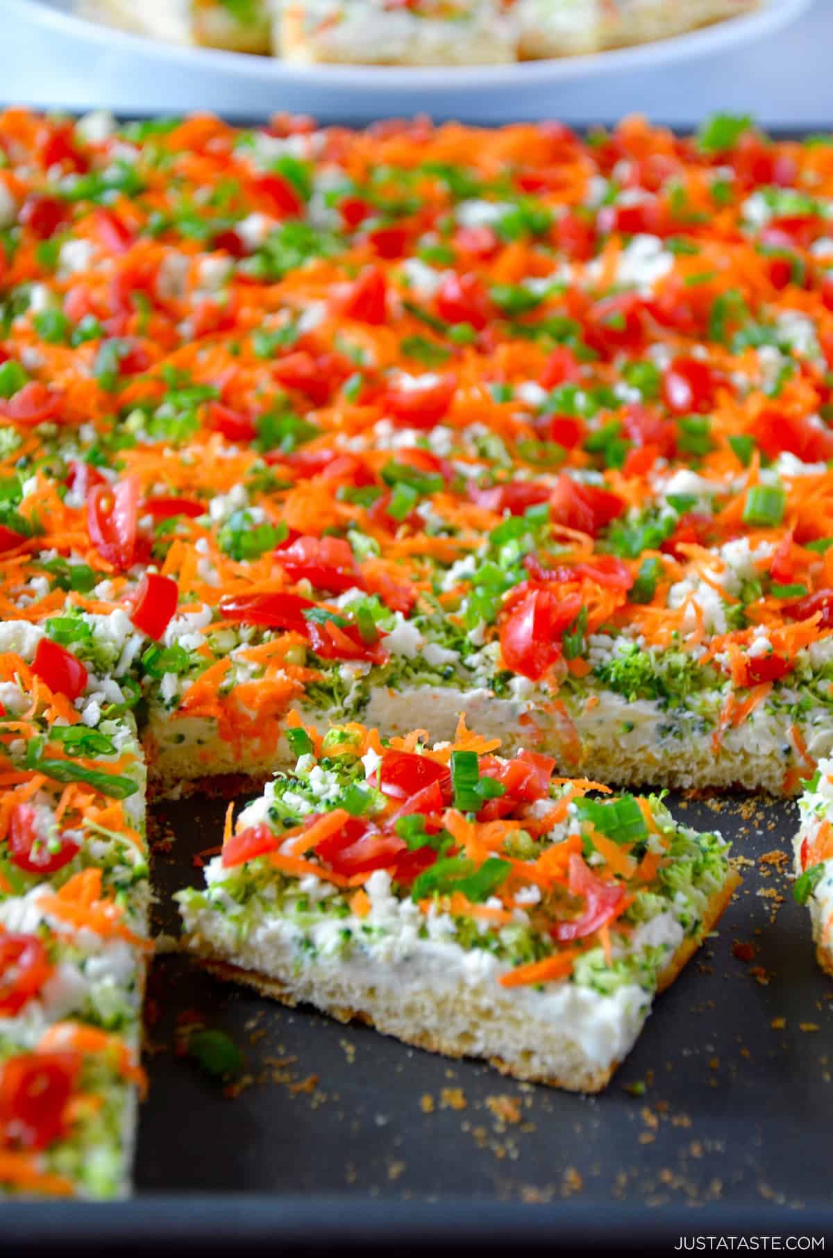 Crescent roll veggie pizza on a baking sheet.