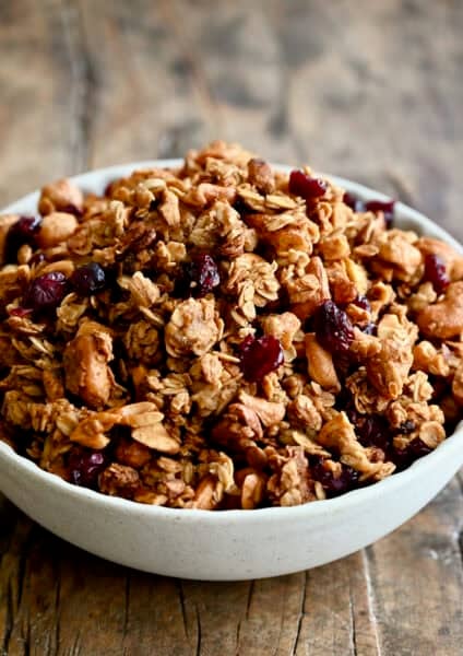 Homemade granola with nuts and dried fruit piled high in a cereal bowl.