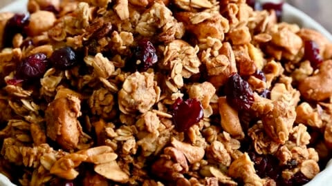 Homemade granola with nuts and dried fruit piled high in a cereal bowl.