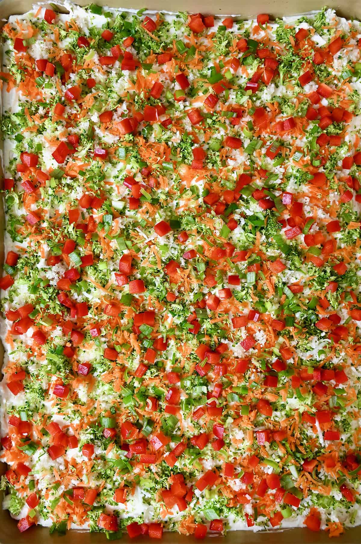 Crescent roll veggie pizza starring a creamy Ranch-cream cheese spread and finely chopped veggies.