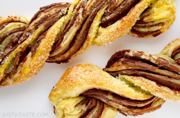A white background with two puff pastry twists made with chocolate