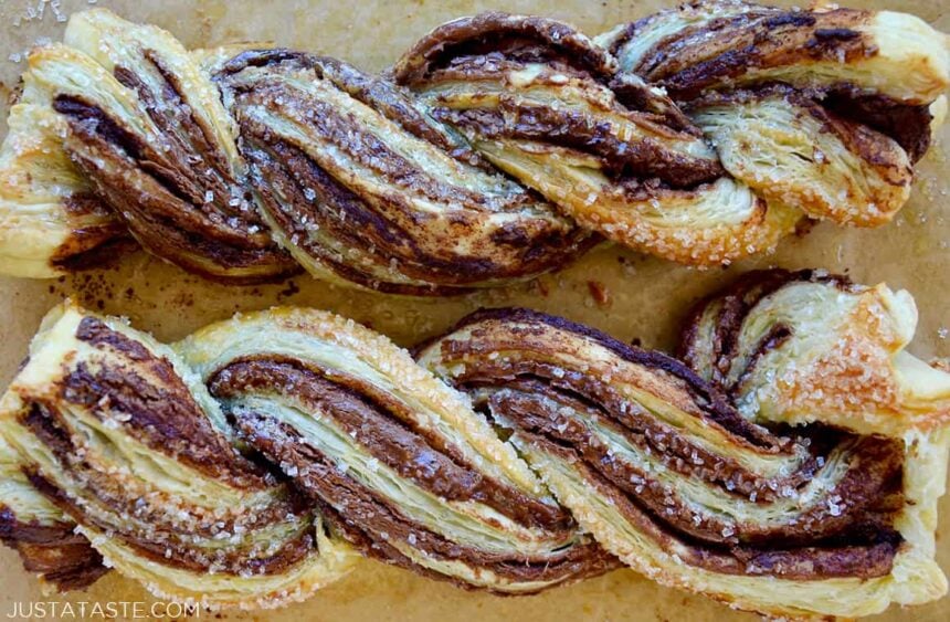 Chocolate puff pastry twists close-up on brown parchment paper