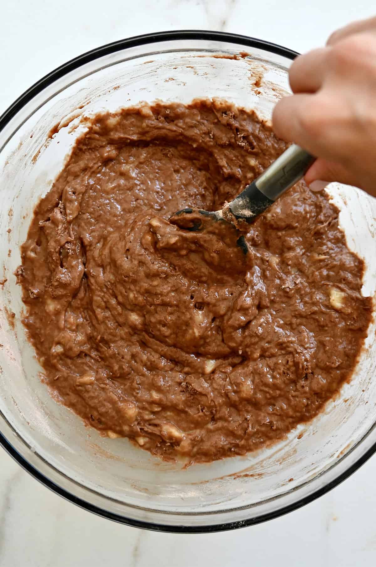 Chocolate banana bread batter in a large mixing bowl.