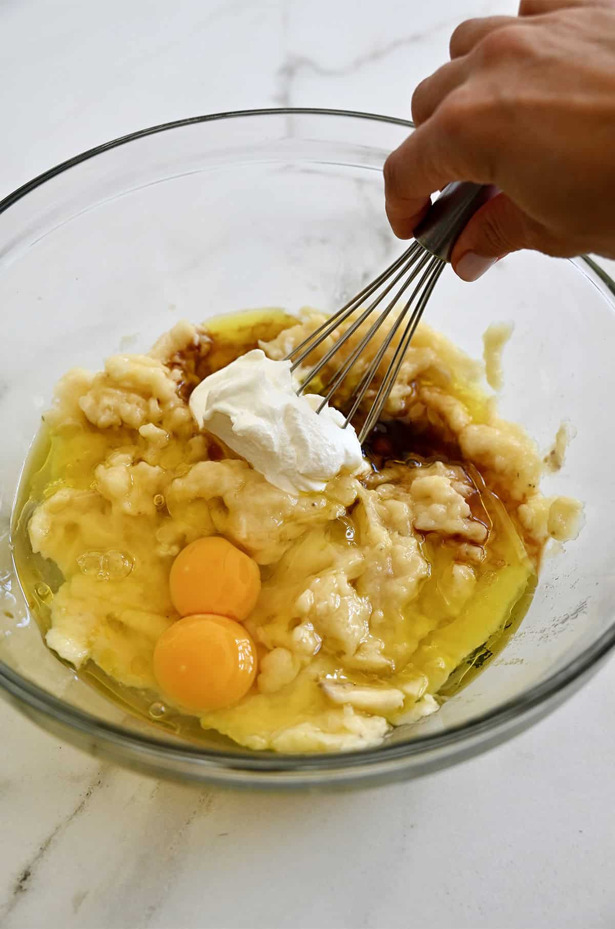 Whisk together the wet ingredients for banana bread.