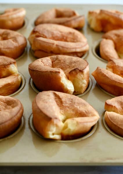 A closeup view of popovers in a muffin pan.