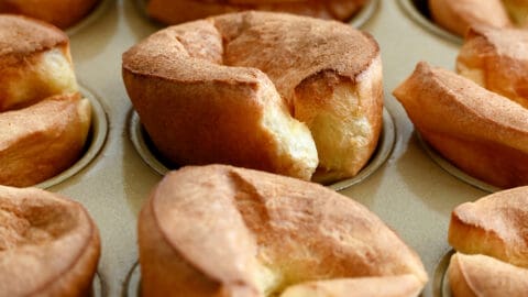 A closeup view of popovers in a muffin pan.