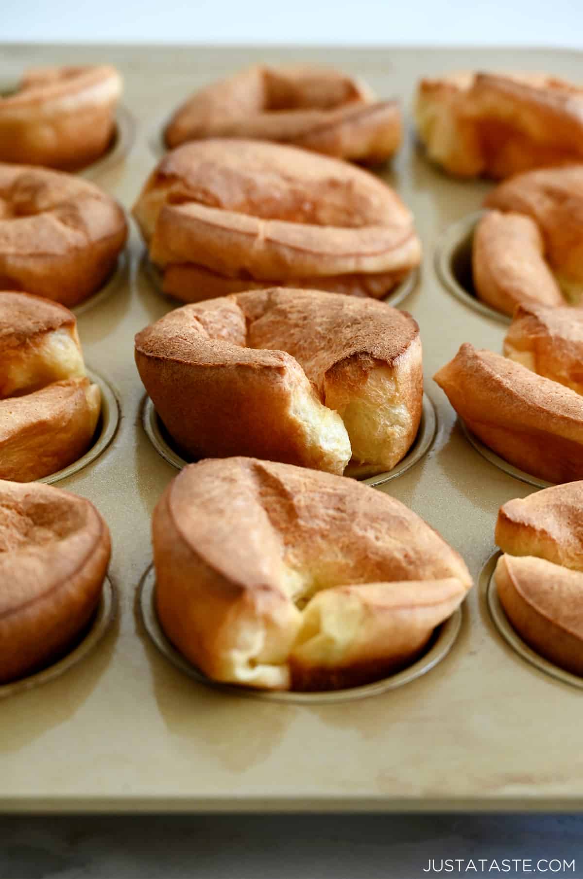 A closeup view of popovers in a muffin pan.