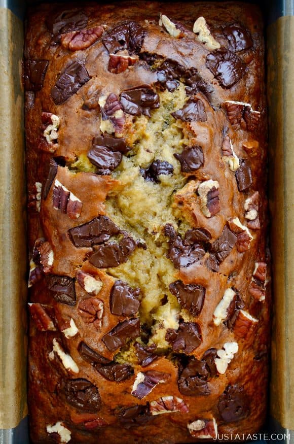 A close-up, top-down view of banana bread made with nuts and chocolate chips