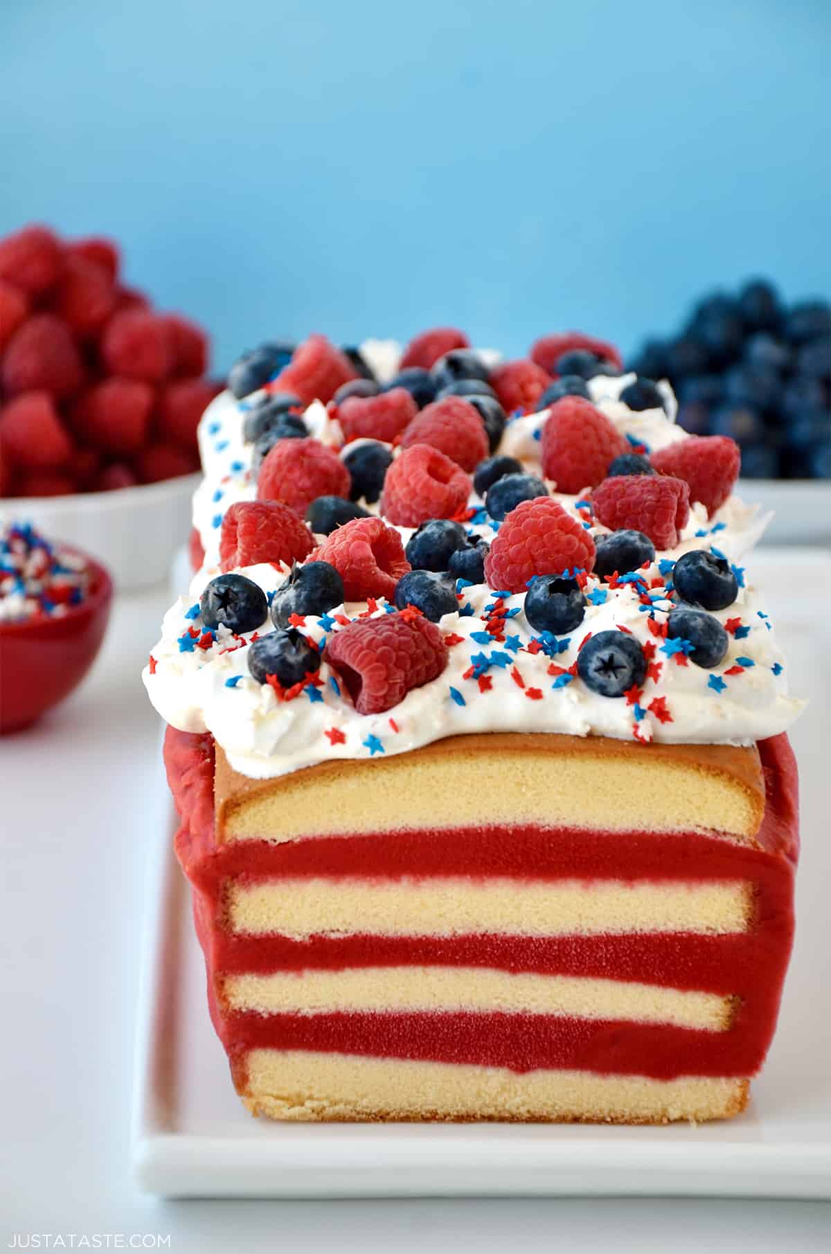 A frozen pound cake layered with raspberry sorbet topped with cool whip, fresh raspberries and blueberries, and patriotic sprinkles.