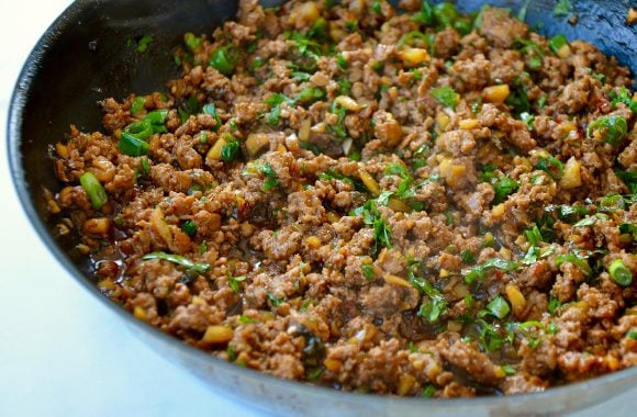 Large sauté pan with cooked ground chicken 
