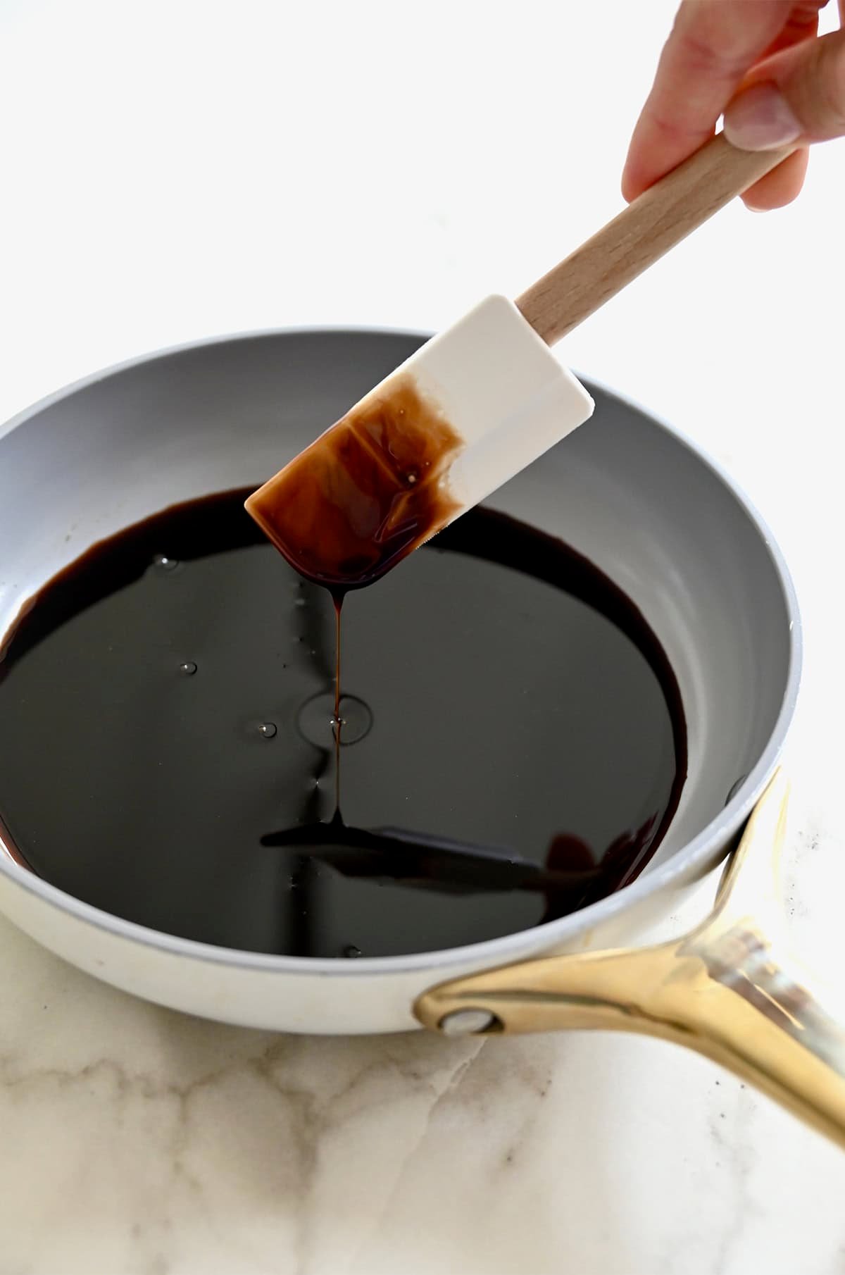 A saucepan containing homemade balsamic syrup.