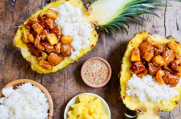 Sticky Pineapple Chicken in hollowed pineapples