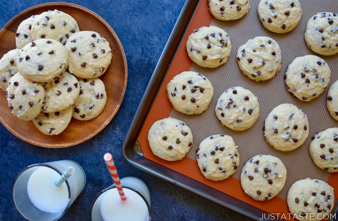 Cake mix chocolate chip cookies on a plate and baking sheet with milk