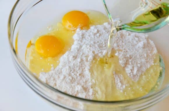 Cake mix in a glass bowl with eggs
