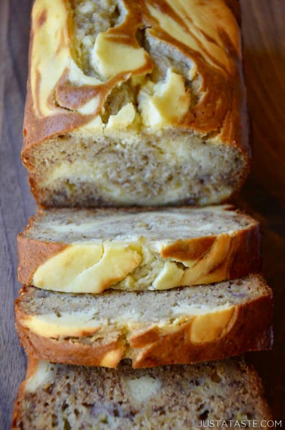 Cream cheese banana bread sliced and served on a cutting board