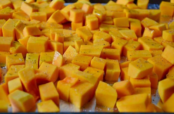 Roasted butternut squash cubes on a baking sheet with foil