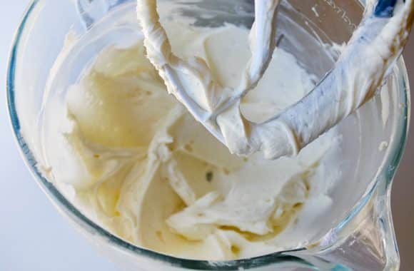 Vanilla buttercream frosting being blended in a KitchenAid stand mixer