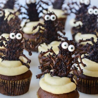 Chocolate Halloween Cupcakes topped with cream cheese frosting and chocolate spiders