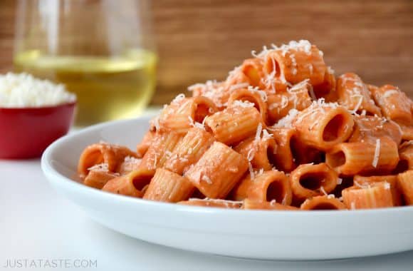 Vodka pasta on a white plate with Parmesan cheese