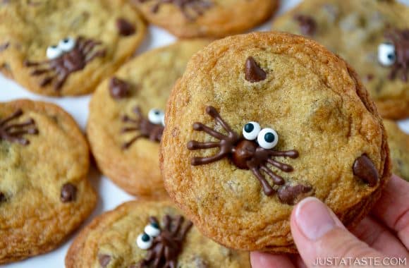Holding a Spider Chocolate Chip Cookie with more cookies in the background