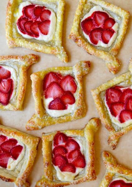 Diamond-shaped cream cheese Danish topped with fresh strawberry slices.