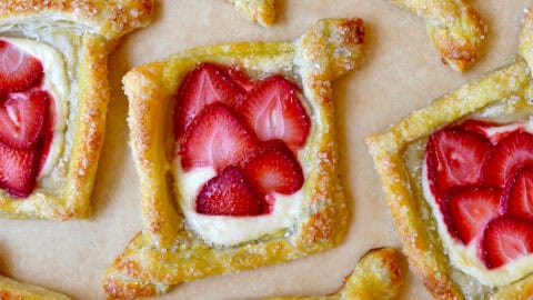 Diamond-shaped cream cheese Danish topped with fresh strawberry slices.