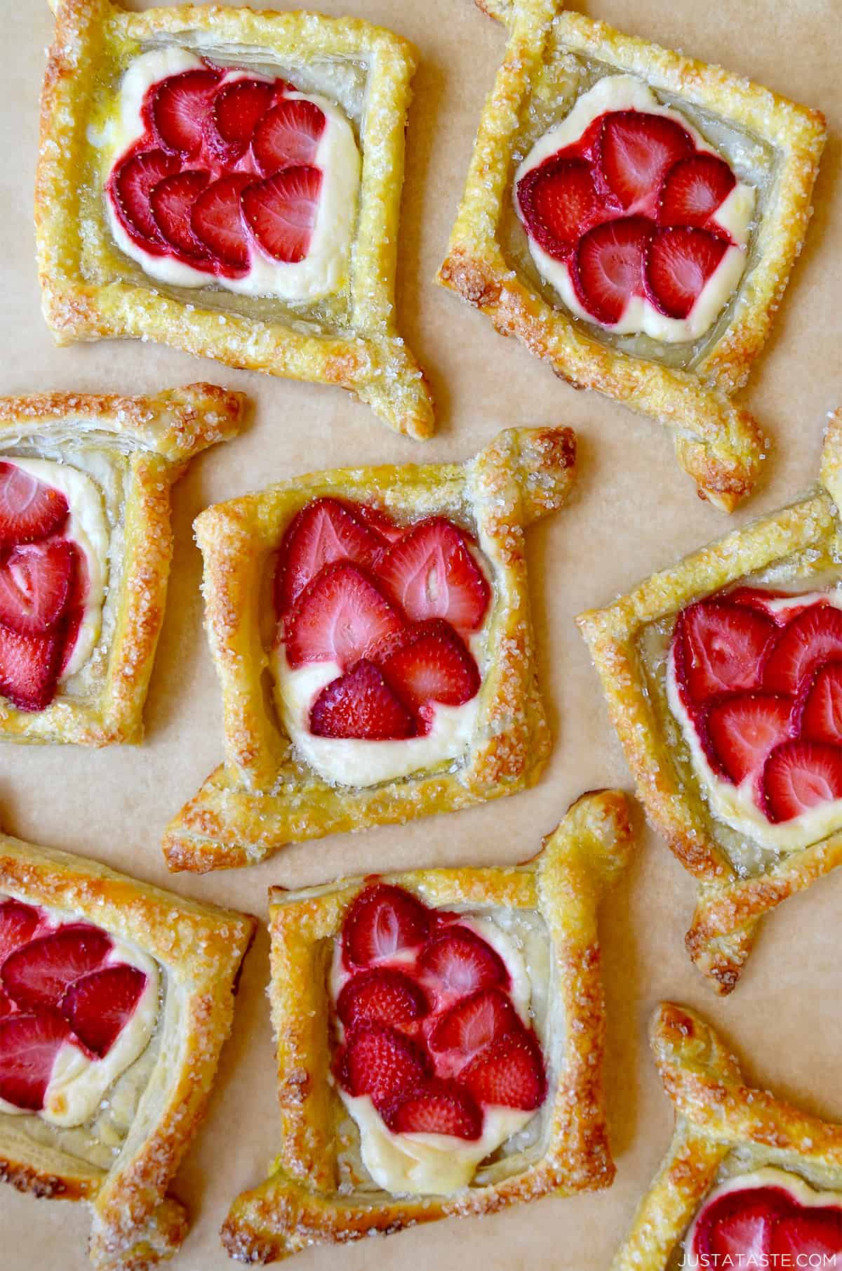 Diamond-shaped cream cheese Danish topped with fresh strawberry slices.