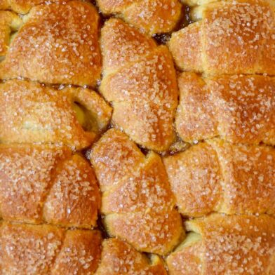 A pan of Crescent Roll Apple Dumplings studded with sanding sugar