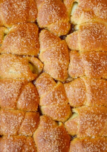 A pan of Crescent Roll Apple Dumplings studded with sanding sugar