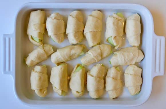 Unbaked crescent roll dumplings in a baking pan