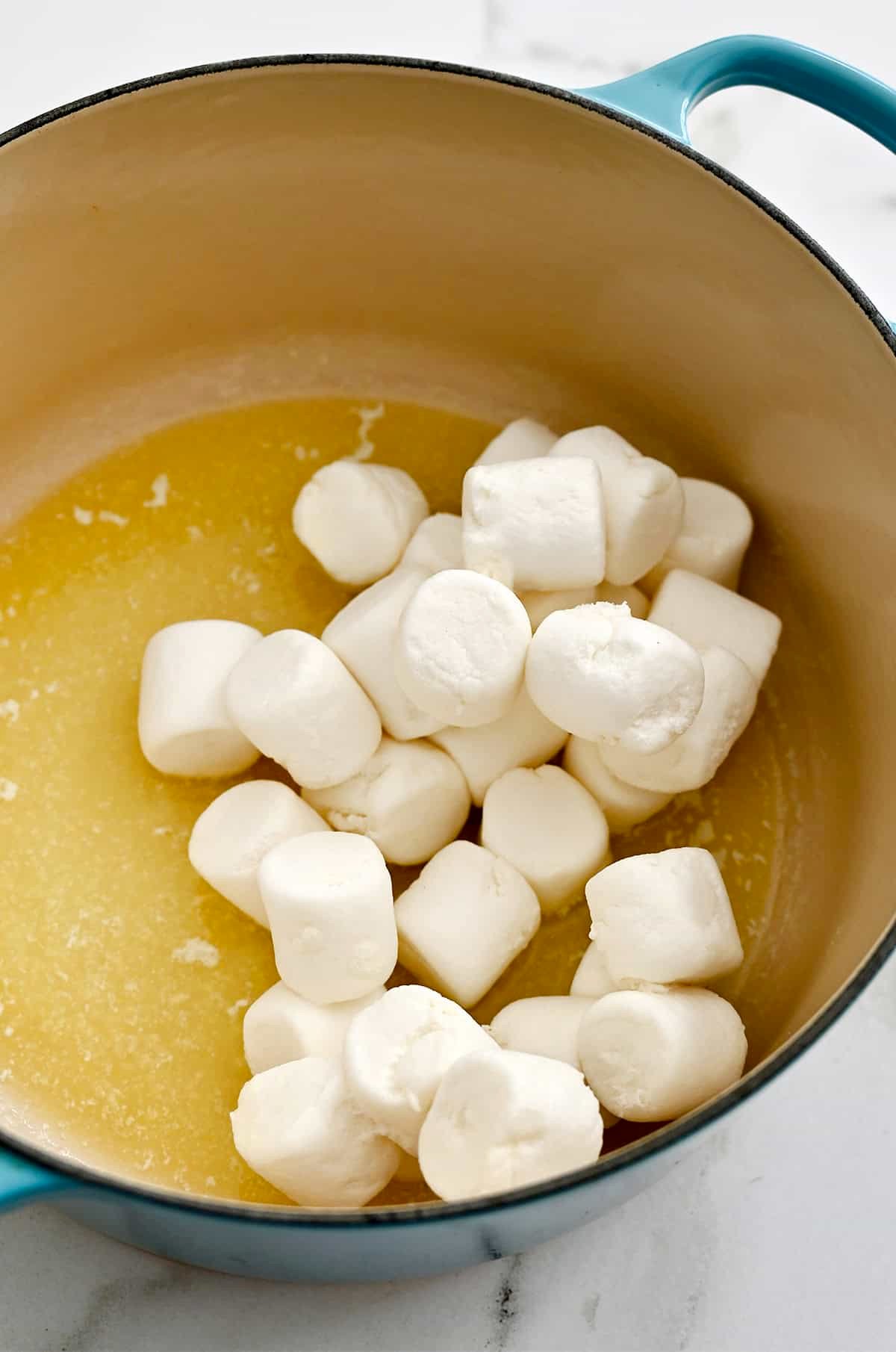 Large marshmallows in a pot with melted butter.