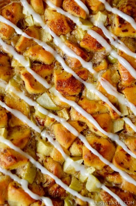 A close-up of Apple Cinnamon Roll Bake with icing drizzled on top