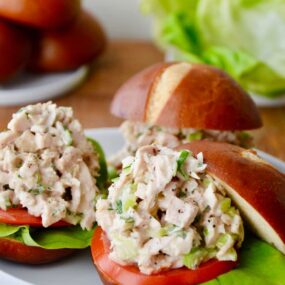 A white plate with leftover turkey sliders on pretzel buns