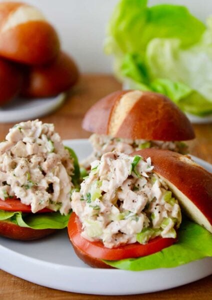 A white plate with leftover turkey sliders on pretzel buns
