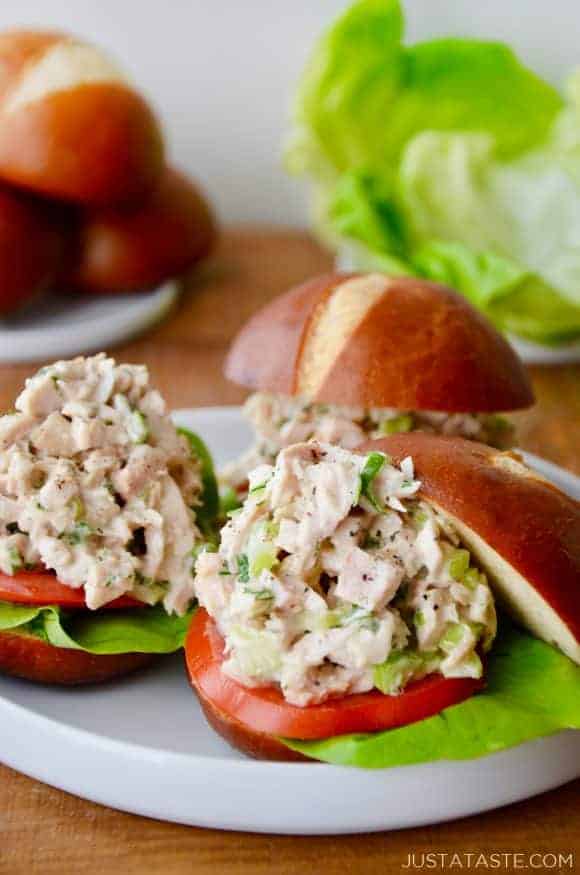 A white plate with leftover turkey sliders on pretzel buns