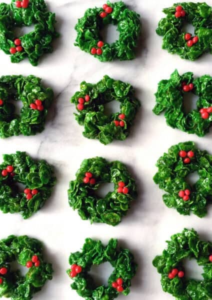 Christmas Cornflake wreath cookies made with green food coloring and Red Hot candies.